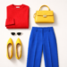 Flat lay colour blocking outfit featuring a red sweater, cobalt blue trousers, and yellow heels arranged in bold colour sections to illustrate the colour blocking fashion styling technique.