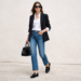 Woman wearing black loafers styled with straight-leg jeans, white button-down shirt and blazer in a polished everyday outfit.