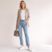 White sneakers styled with straight-leg jeans, white T-shirt and blazer in a clean minimalist outfit.