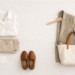 Neutral slow fashion capsule wardrobe flat lay featuring linen shirt, tailored blazer, trousers, loafers and tote bag in minimalist aesthetic.