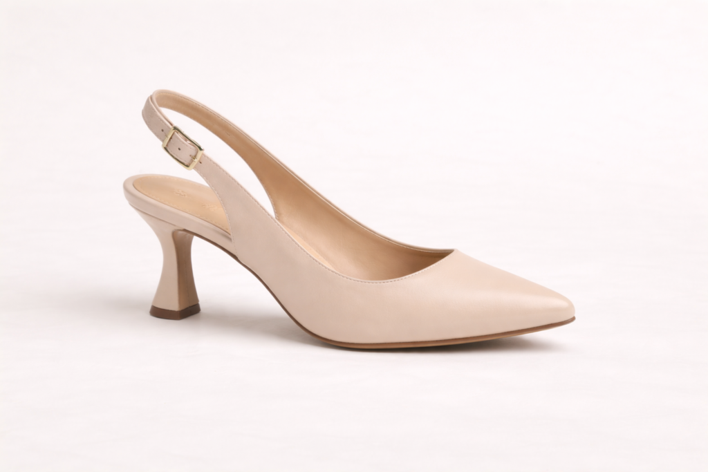 Single women’s spool heel shoe on neutral background showing a curved vintage-inspired heel design.